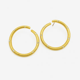 Gold hoop earrings with embedded stones on a white background
