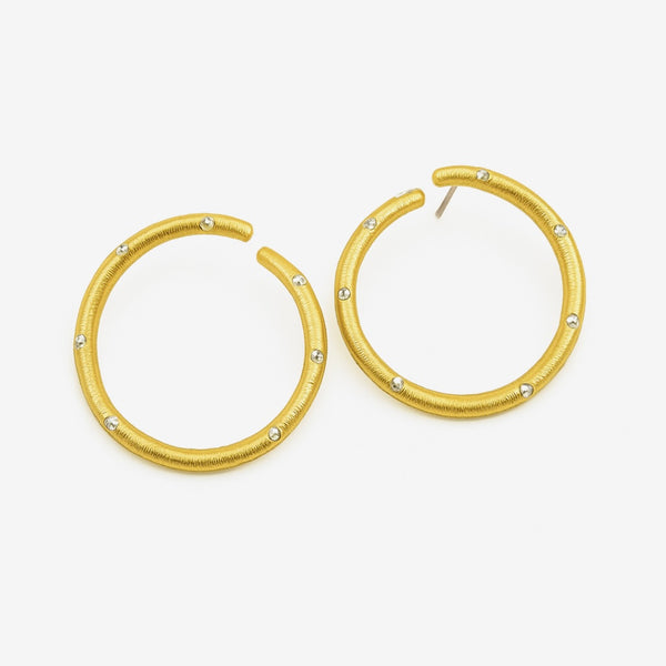 Gold hoop earrings with embedded stones on a white background