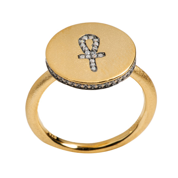 A vermeil gold ring with a clear cubic zirconia Ankh symbol design on the top surface.