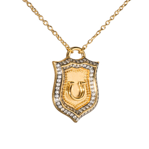 A gold-plated sterling silver horseshoe pendant necklace with round-cut zircon stones, displayed on a plain background.